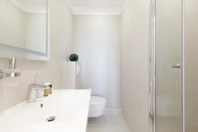 a white bathroom with a toilet and a shower at Great Sea View YourHostHelper in Cannes