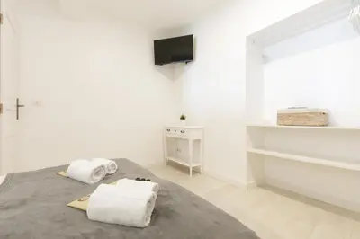 a white bedroom with two towels on a bed at Great Sea View YourHostHelper in Cannes