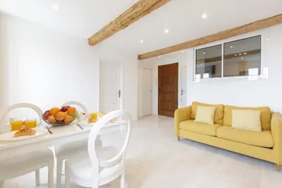 a living room with a yellow couch and a table at Great Sea View YourHostHelper in Cannes