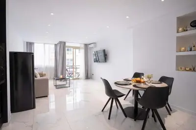a white bathroom with a toilet and a shower at 