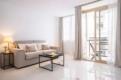 a white living room with a table and chairs at 