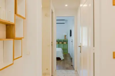 a hallway leading to a bedroom with a bed at 90m on the Croisette with Terrace & Sea View in Cannes