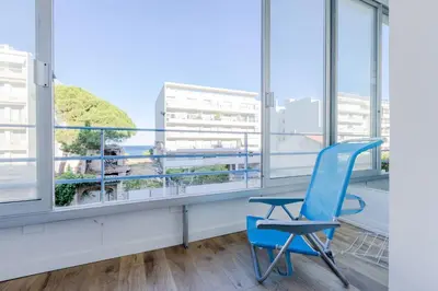 an office with a blue chair and a window at 90m on the Croisette with Terrace & Sea View in Cannes