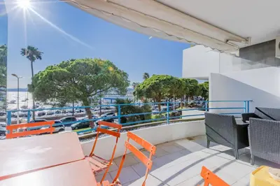a balcony with orange chairs and a view of the ocean at 90m on the Croisette with Terrace & Sea View in Cannes