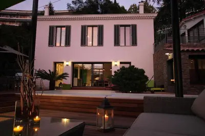 a white house with lights on a patio at SUPERBE MAISON DE VILLE in Cannes