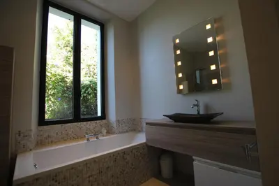a bathroom with a tub and a sink and a window at SUPERBE MAISON DE VILLE in Cannes