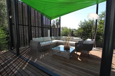 a patio with a couch and a table on a deck at SUPERBE MAISON DE VILLE in Cannes