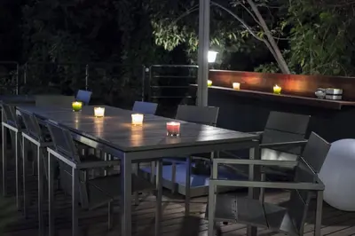 a table and chairs on a patio at night at SUPERBE MAISON DE VILLE in Cannes