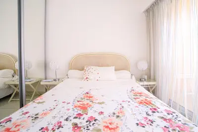 a bedroom with a bed with a floral bedspread at Appartement Les Allées in Cannes