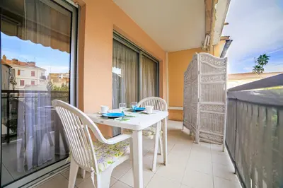 a white table and chairs on a balcony at Appartement Les Allées in Cannes