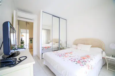 a bedroom with a bed and a television in it at Appartement Les Allées in Cannes