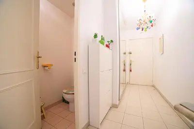 a bathroom with a toilet and a white cabinet at Appartement Les Allées in Cannes