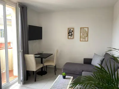 a living room with a couch and a table at Kimi Résidence in Cannes