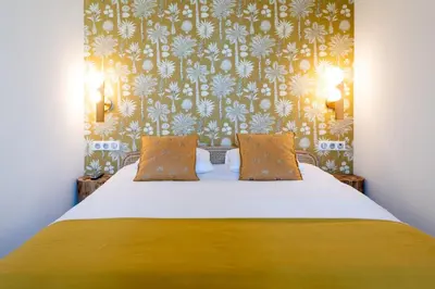 a bedroom with a bed with a yellow bedspread at Luxury Apartment - Heart of Cannes - Rue d'Antibes in Cannes