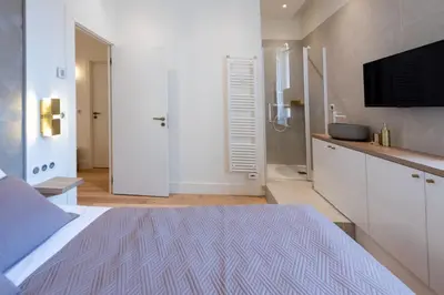 a bedroom with a bed and a flat screen tv at Luxury Apartment - Heart of Cannes - Rue d'Antibes in Cannes