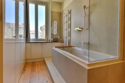 a bathroom with a tub and a glass shower at Luxury Apartment - Heart of Cannes - Rue d'Antibes in Cannes