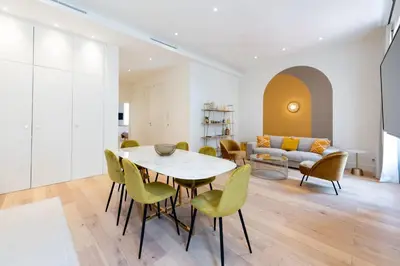 a living room with a table and chairs and a couch at Luxury Apartment - Heart of Cannes - Rue d'Antibes in Cannes