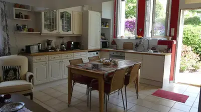 a kitchen with a table and chairs and a table and a table and chairsktop at Charmant appartement dans villa avec parc in Cannes