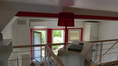 a room with a staircase with red trim and a window at Charmant appartement dans villa avec parc in Cannes