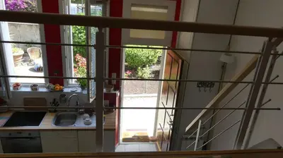 a kitchen with a sink and a door to a yard at Charmant appartement dans villa avec parc in Cannes