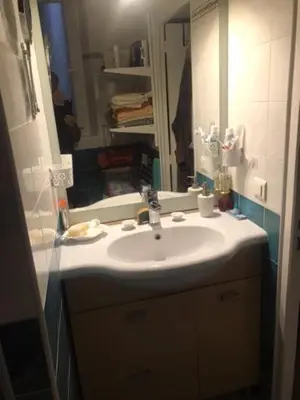 a bathroom with a sink and a mirror at Charmant appartement dans villa avec parc in Cannes