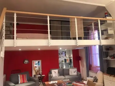 a living room with a loft bed in a room at Charmant appartement dans villa avec parc in Cannes