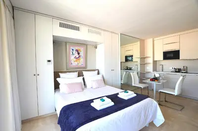 a bedroom with a bed with two towels on it at Studio Cannes Grand Hôtel Ibis avec Terrasse in Cannes