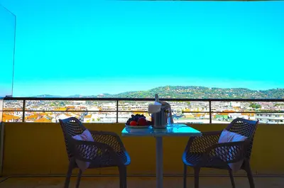 a table with two chairs and a table with a view at Studio Cannes Grand Hôtel Ibis avec Terrasse in Cannes