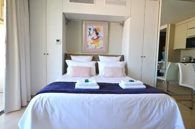 a bedroom with a bed with towels on it at Studio Cannes Grand Hôtel Ibis avec Terrasse in Cannes