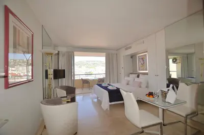 a hotel room with a bed and a table and chairs at Studio Cannes Grand Hôtel Ibis avec Terrasse in Cannes