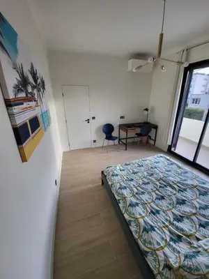 a bedroom with a bed and a desk and a window at VILLA BEL AIR CANNES - 240m2 - Freshly completely renovated - Beach - Pool - No Party allowed - No bachelor-ette stay in Cannes
