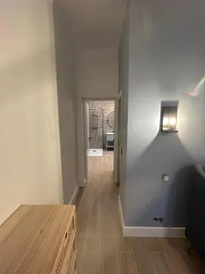 a room with a hallway with a table and a door at VILLA BEL AIR CANNES - 240m2 - Freshly completely renovated - Beach - Pool - No Party allowed - No bachelor-ette stay in Cannes