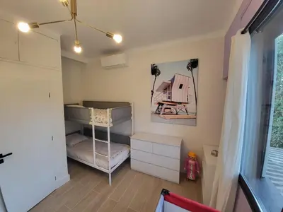 a small bedroom with bunk beds and a room with a window at VILLA BEL AIR CANNES - 240m2 - Freshly completely renovated - Beach - Pool - No Party allowed - No bachelor-ette stay in Cannes