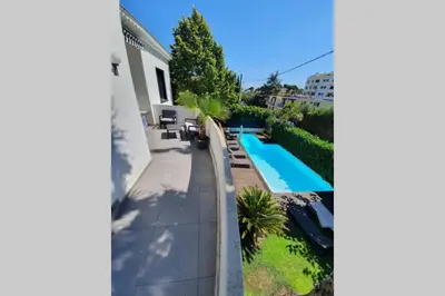a backyard with a swimming pool and a house at VILLA BEL AIR CANNES - 240m2 - Freshly completely renovated - Beach - Pool - No Party allowed - No bachelor-ette stay in Cannes