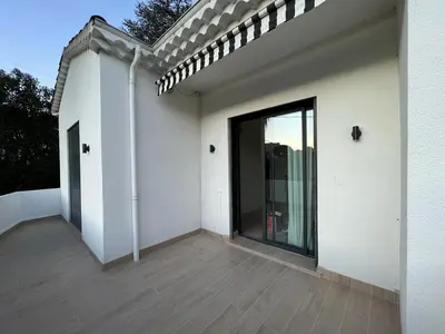 a white house with a large glass door at VILLA BEL AIR CANNES - 240m2 - Freshly completely renovated - Beach - Pool - No Party allowed - No bachelor-ette stay in Cannes