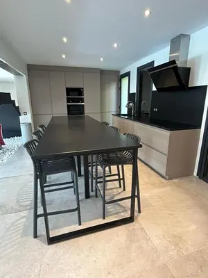 a kitchen with a black table and chairs in it at VILLA BEL AIR CANNES - 240m2 - Freshly completely renovated - Beach - Pool - No Party allowed - No bachelor-ette stay in Cannes