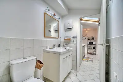 a bathroom with a toilet and a sink and a mirror at IMMOGROOM - cosy - Forville market - sea view in Cannes
