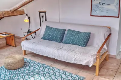 a living room with a couch with blue pillows at IMMOGROOM - cosy - Forville market - sea view in Cannes