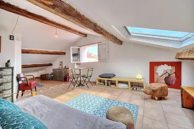 a living room with a skylight in the ceiling at IMMOGROOM - cosy - Forville market - sea view in Cannes