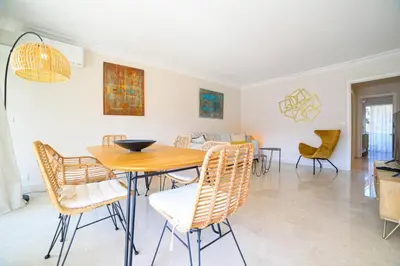 a dining room with a table and chairs at Le Bain De Soleil - Le Bain De Soleil 5 star Two bedroom apartment in Cannes