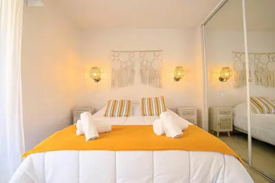 a bedroom with a large bed with towels on it at Le Bain De Soleil - Le Bain De Soleil 5 star Two bedroom apartment in Cannes