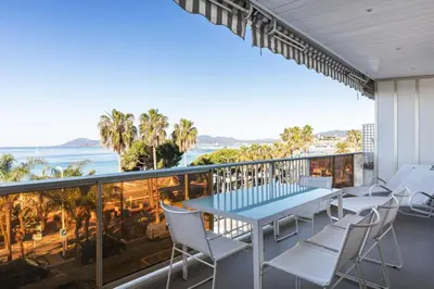 a balcony with a table and chairs and the ocean at REF 1426 - Cannes Croisette - Sea view apartment for rent in Cannes