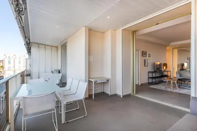 a dining room with a table and white chairs at REF 1426 - Cannes Croisette - Sea view apartment for rent in Cannes