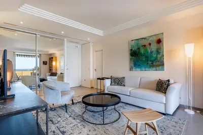 a living room with a couch and a table at REF 1426 - Cannes Croisette - Sea view apartment for rent in Cannes