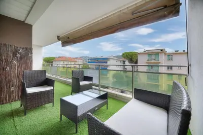 a balcony with chairs and a table and a view at IMMOGROOM - Terrace - Near shops - Parking - Wifi - AC livingroom in Cannes