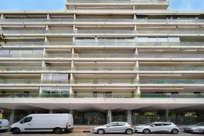 a large building with cars parked in front of it at IMMOGROOM - Terrace - Near shops - Parking - Wifi - AC livingroom in Cannes