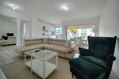a living room with a couch and a chair and a table at IMMOGROOM - Terrace - Near shops - Parking - Wifi - AC livingroom in Cannes