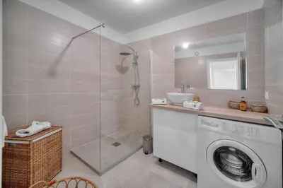 a bathroom with a washing machine and a shower at IMMOGROOM - Terrace - Near shops - Parking - Wifi - AC livingroom in Cannes