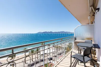 a balcony with chairs and a view of the ocean at Kiss in Cannes