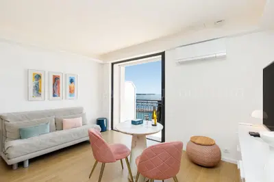 a living room with a couch and a table and chairs at Kiss in Cannes